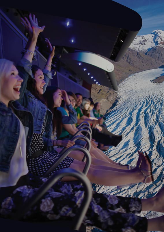 A group of people on the FlyOver Iceland flight ride above a glacier view