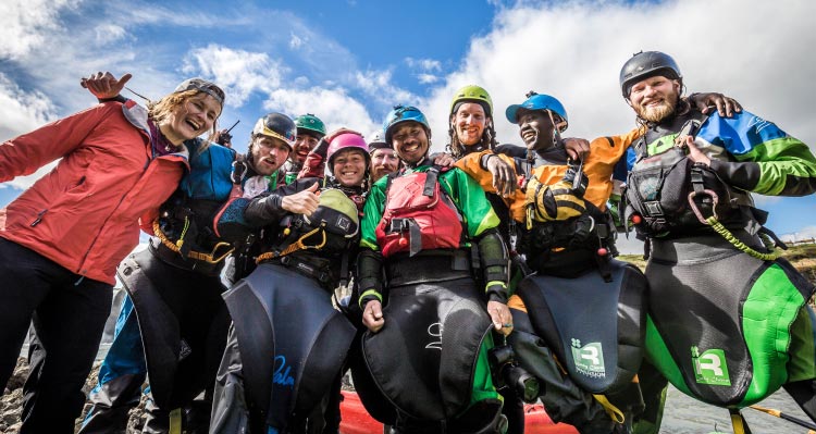 A group of kayakers pose for a photo