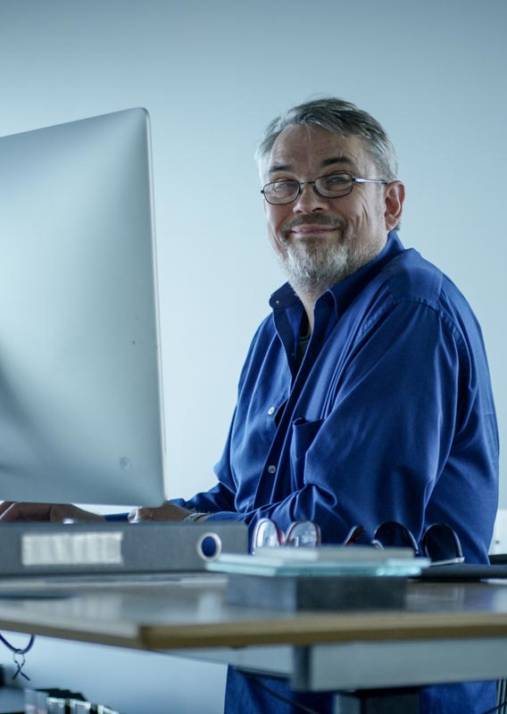 Architect Páll Hjaltason sits at his work desk