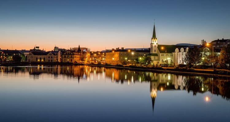 The small Tjörnin lake in central Reykjavík with a prominent church along the shore.