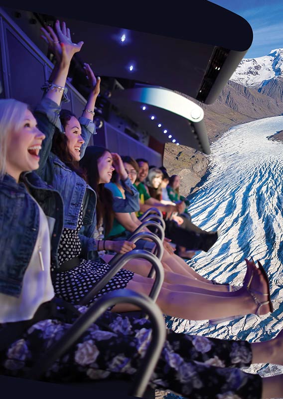 A group of people are excited to be on the FlyOver Iceland flight ride