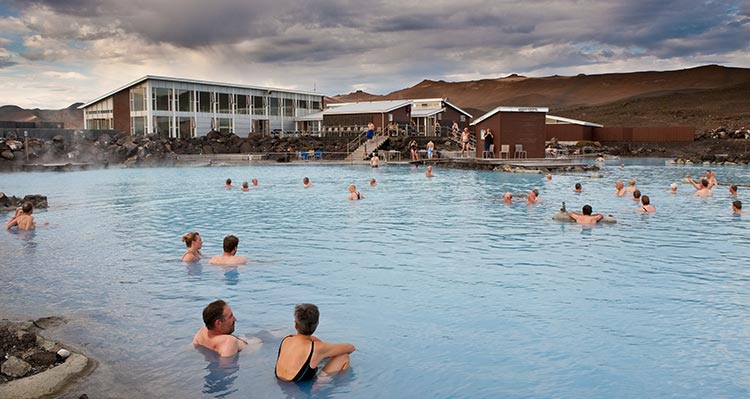 A group of people relaxing in an outdoor pool.