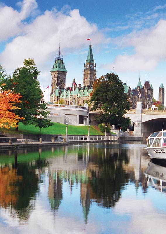 A view along a canal with a boat docked in place.