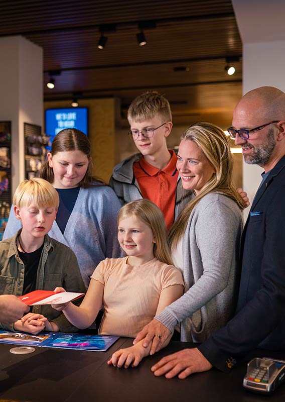 Flyover Iceland guests picking up their tickets at the front desk.